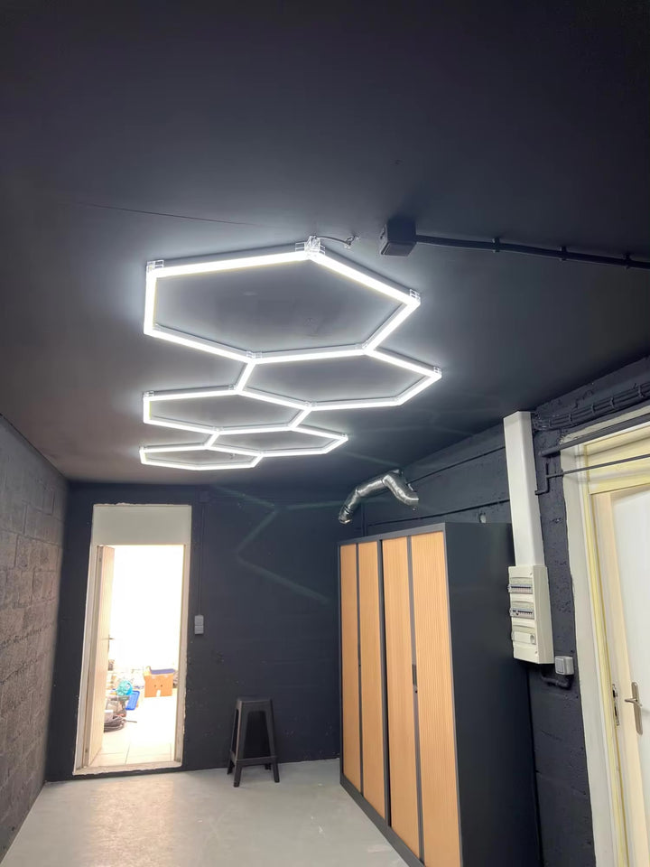 long 5 hexagon lighting on black ceiling
