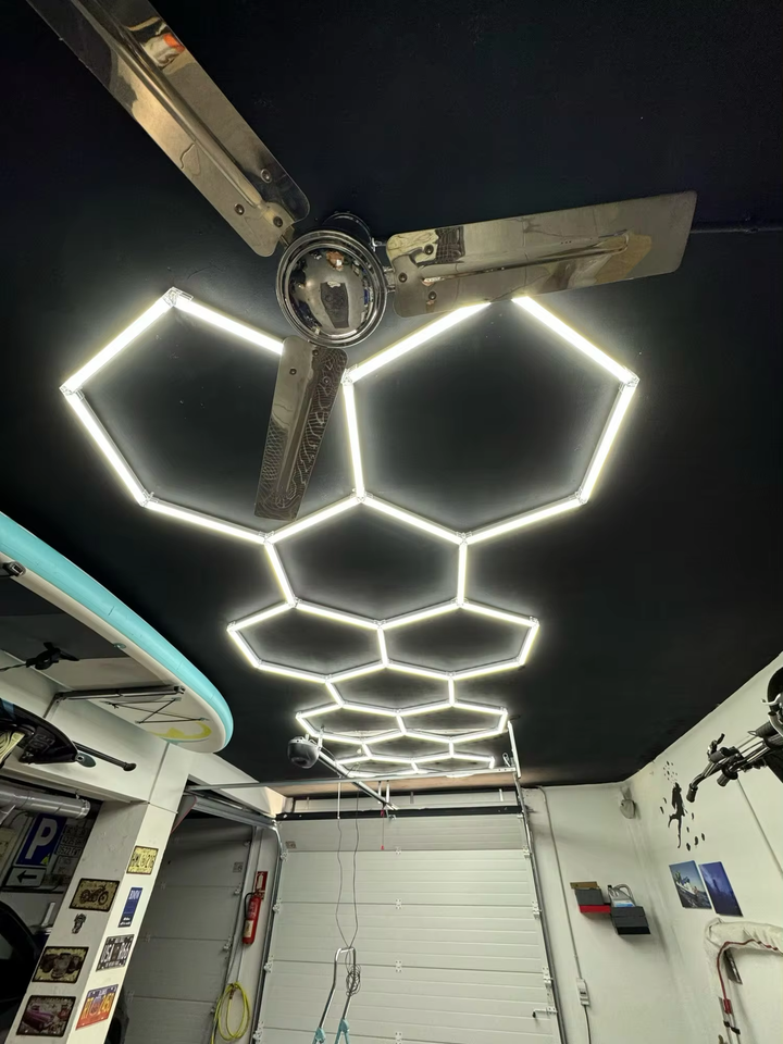 long 11 hexagon lighting on black ceiling 